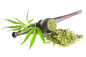 Cannabis sativa. Marijuana leaf, pipe and ready to use dry produ